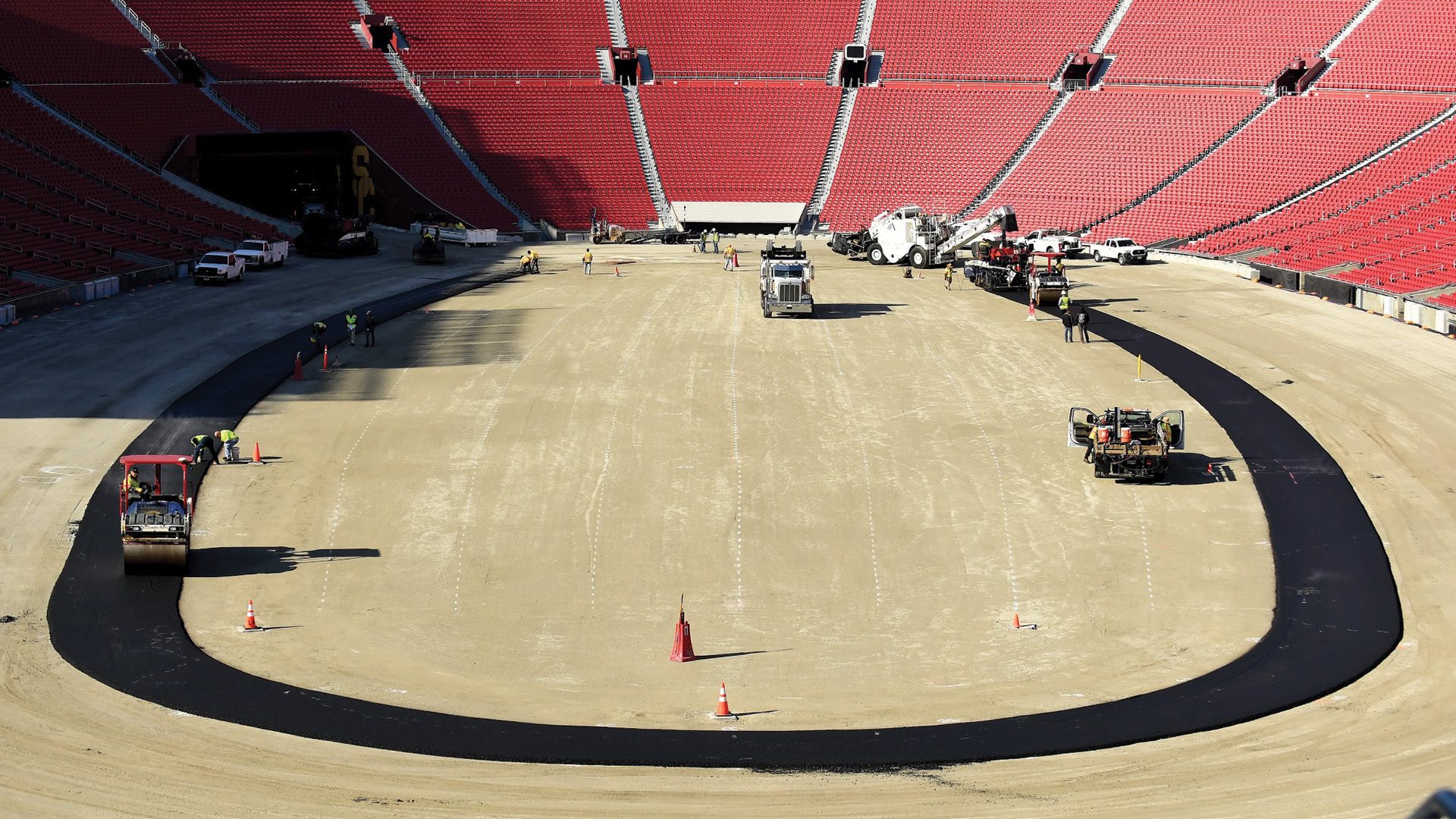 Work crews begin paving the track at the Coliseum in preparation for a NASCAR race