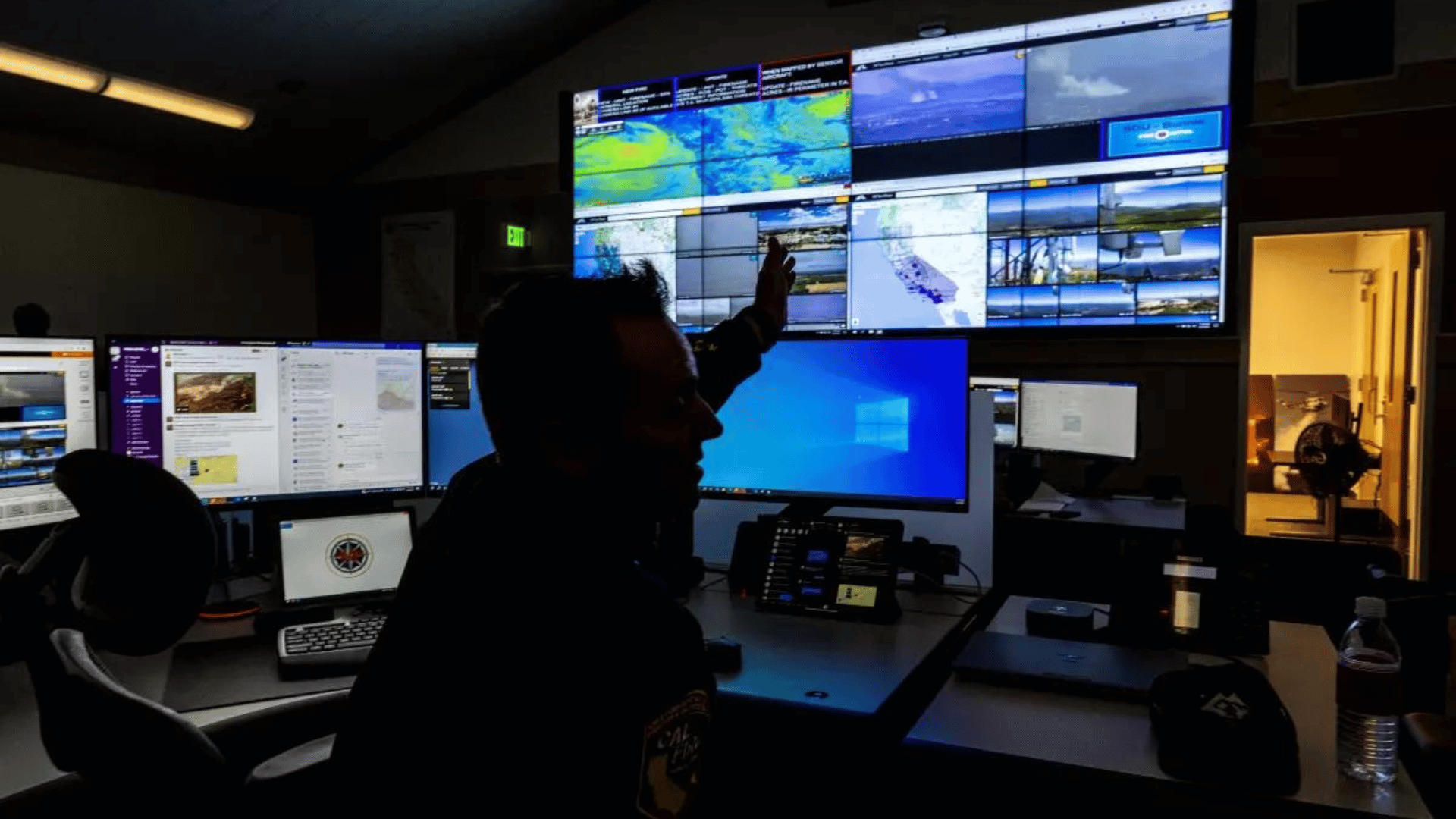 Cal Fire Battalion Chief Scott Slumpff keeps an eye on computer screens at a wildfire monitoring center in Moreno Valley.