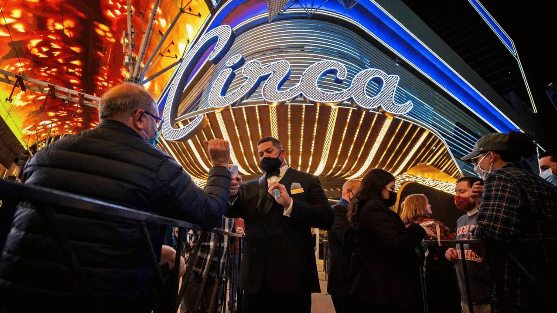 Guests getting their temperatures taken outside Circa while waiting to enter the resort during its first night in 2020